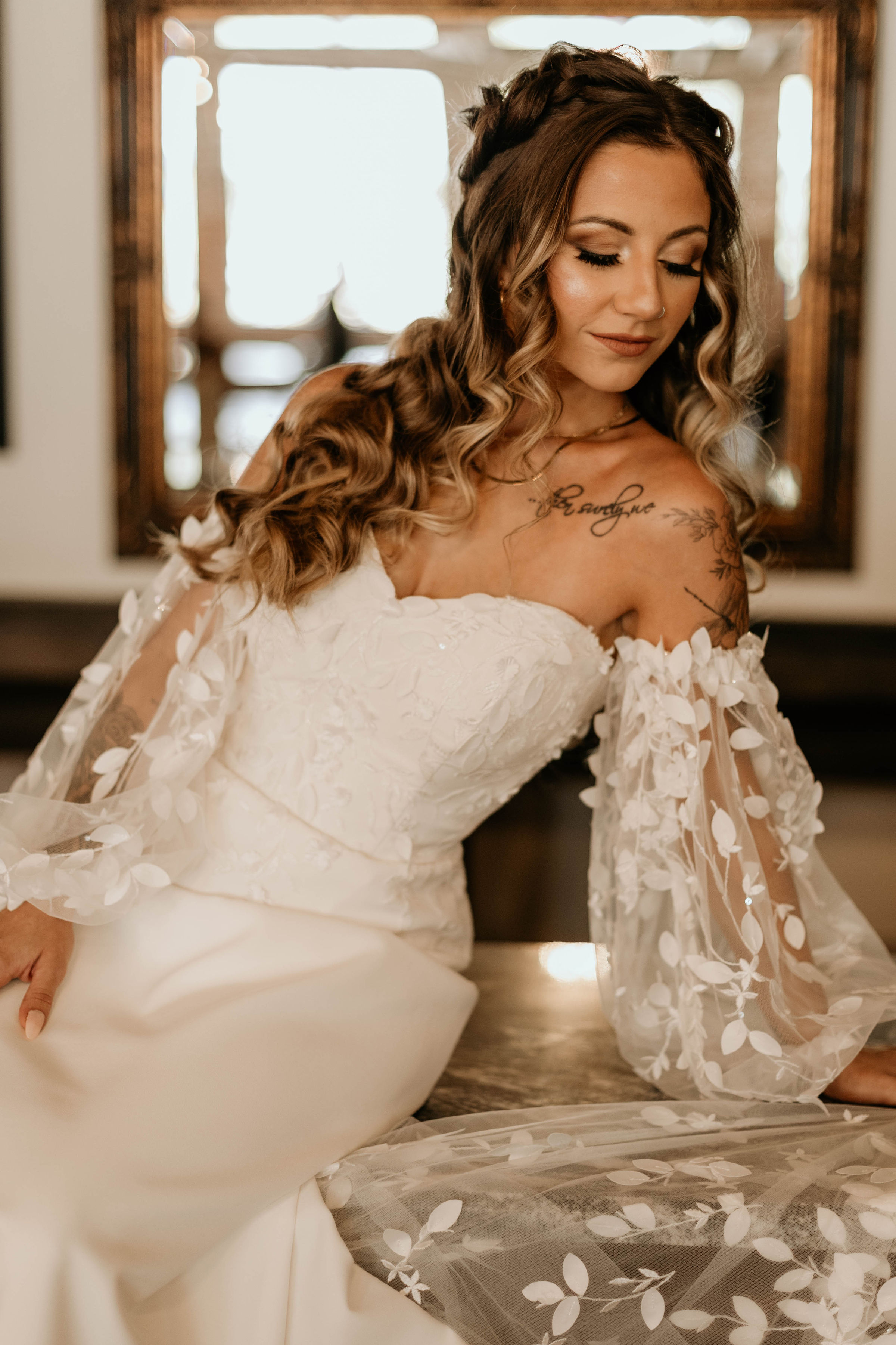 Bride with long curled hair in a lace wedding gown