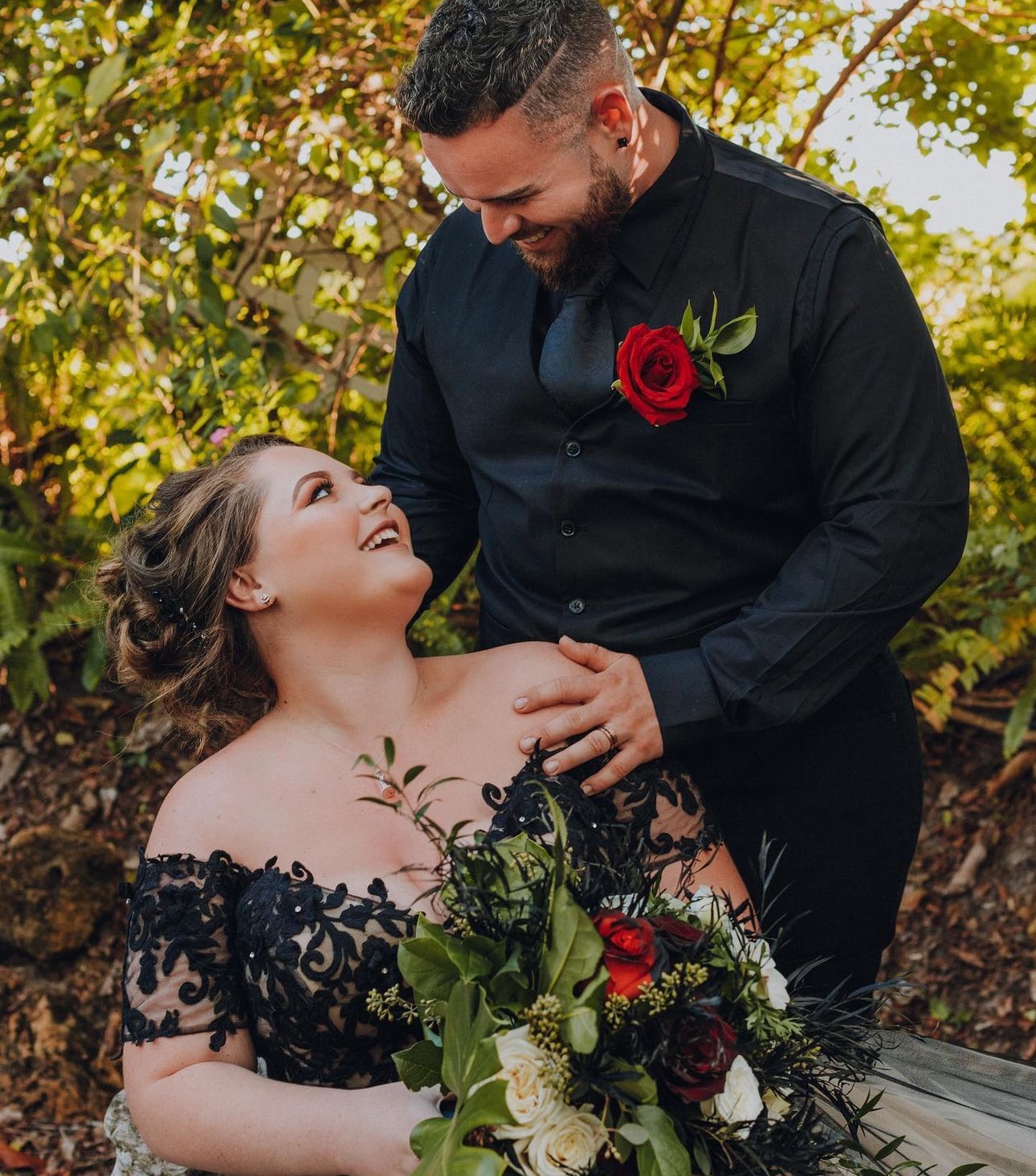 Bride and groom sharing a smile in a garden