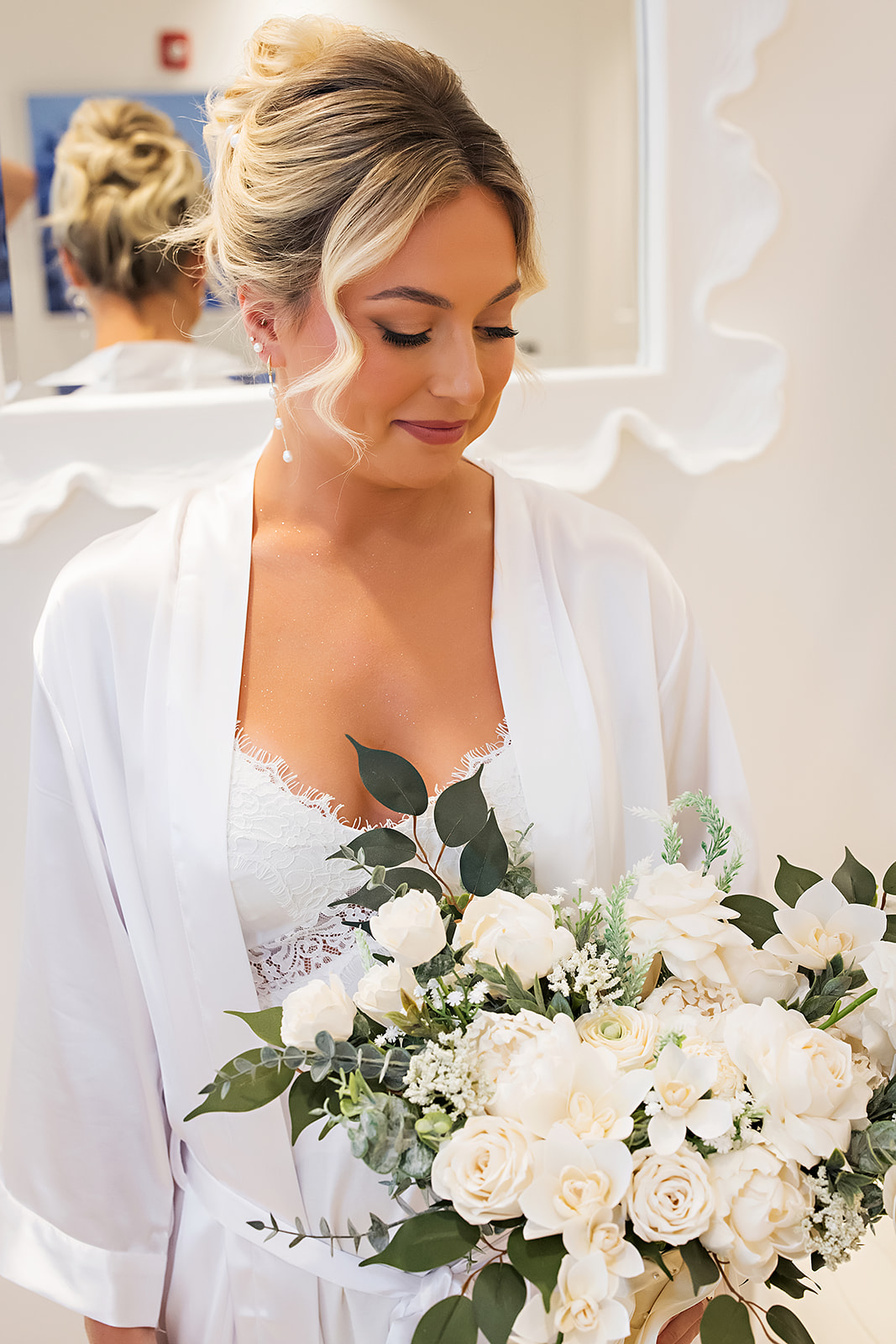 Blonde bride with a soft updo and white bouquet