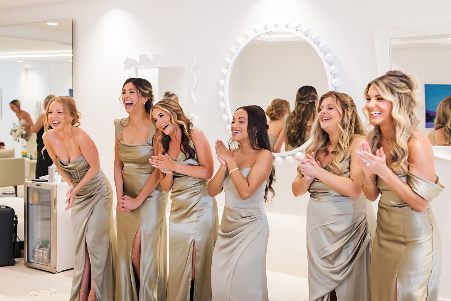 Bridesmaids reacting to the bride’s finished look