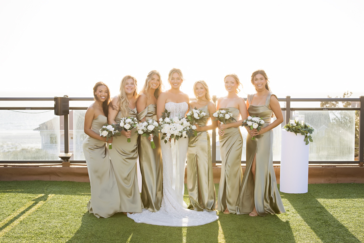 Bride and bridesmaids together at the outdoor venue