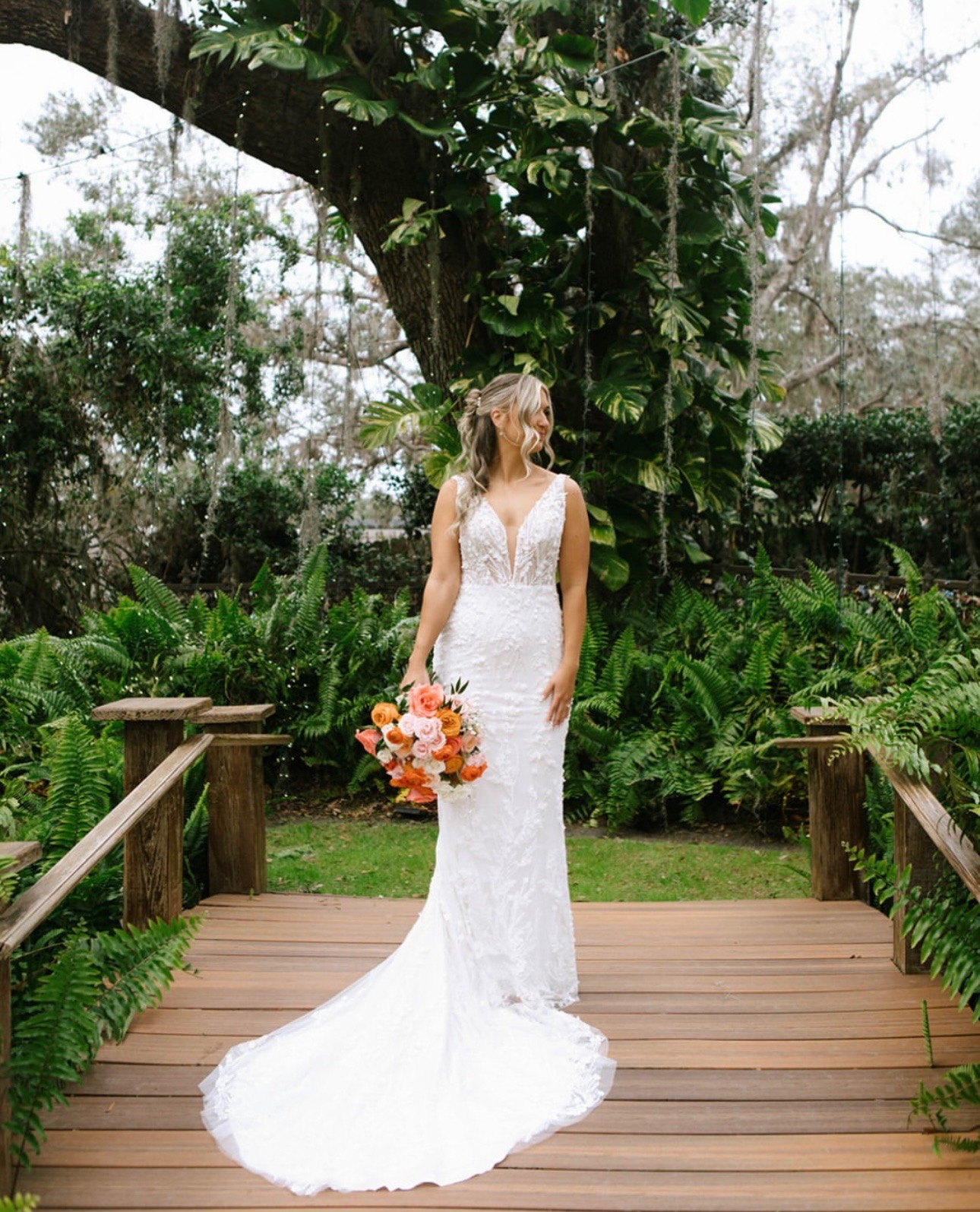 Bride with long curled hair photographed outdoors