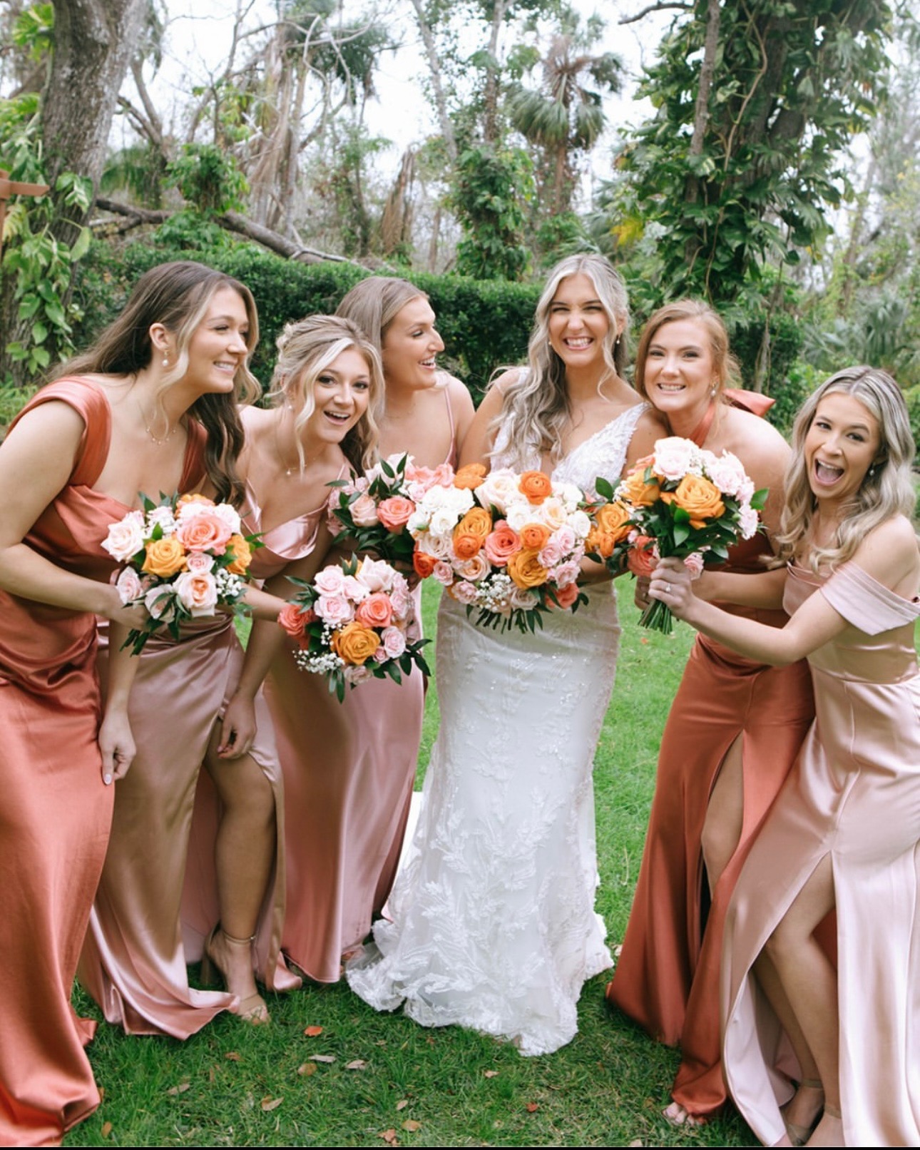 Bride and wedding party outdoors with flowers