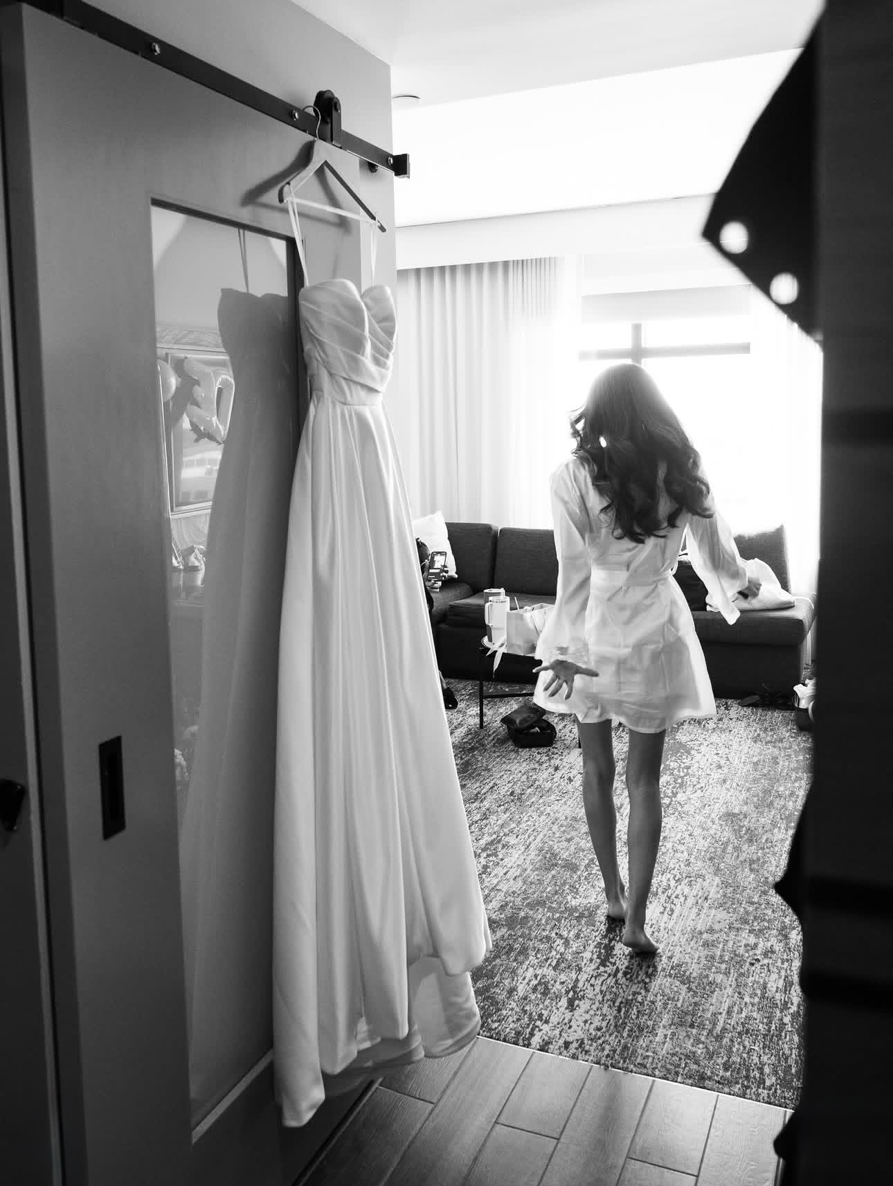 Bride getting ready beside her dress