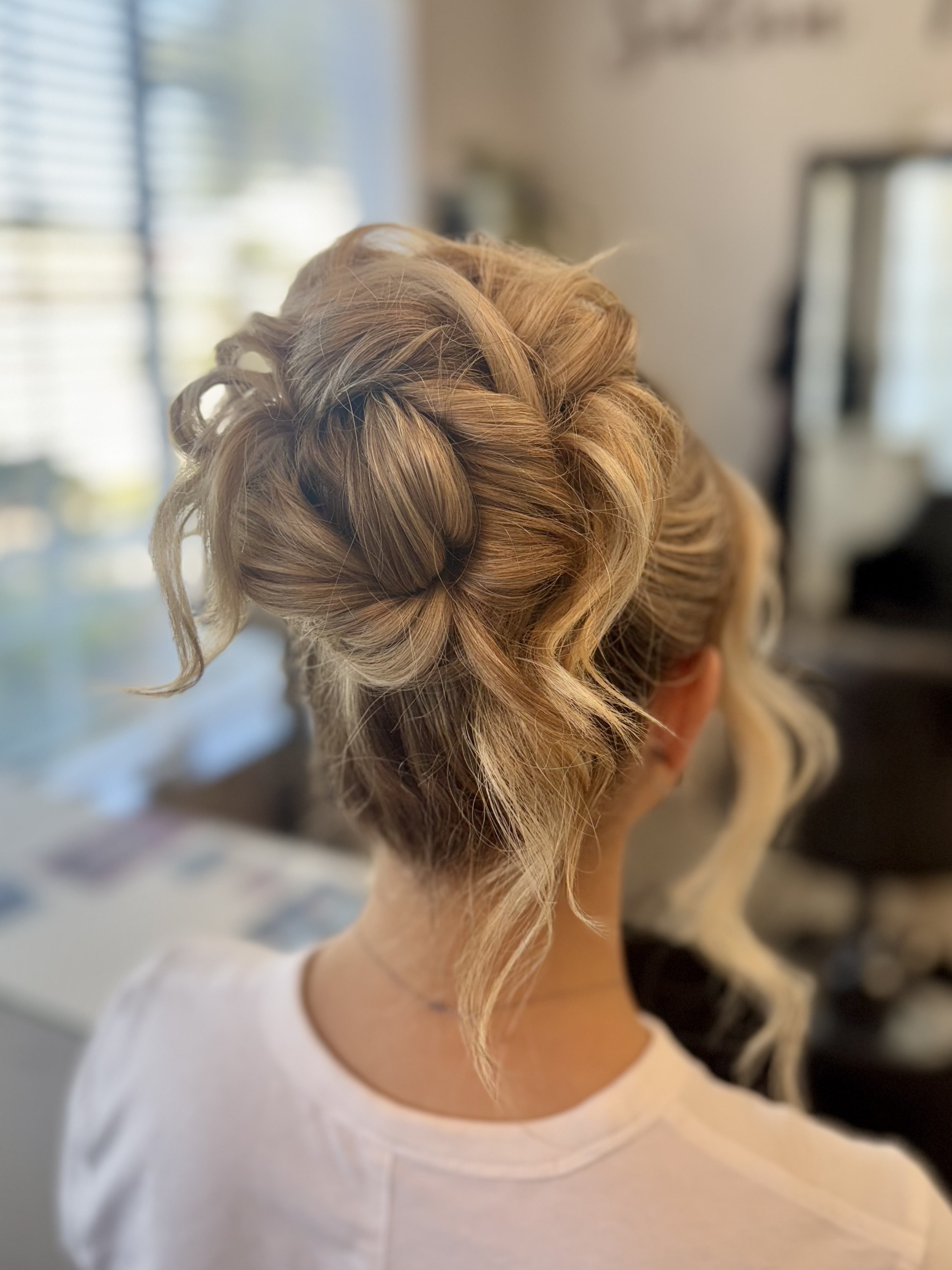 Soft blonde bridal updo seen from behind