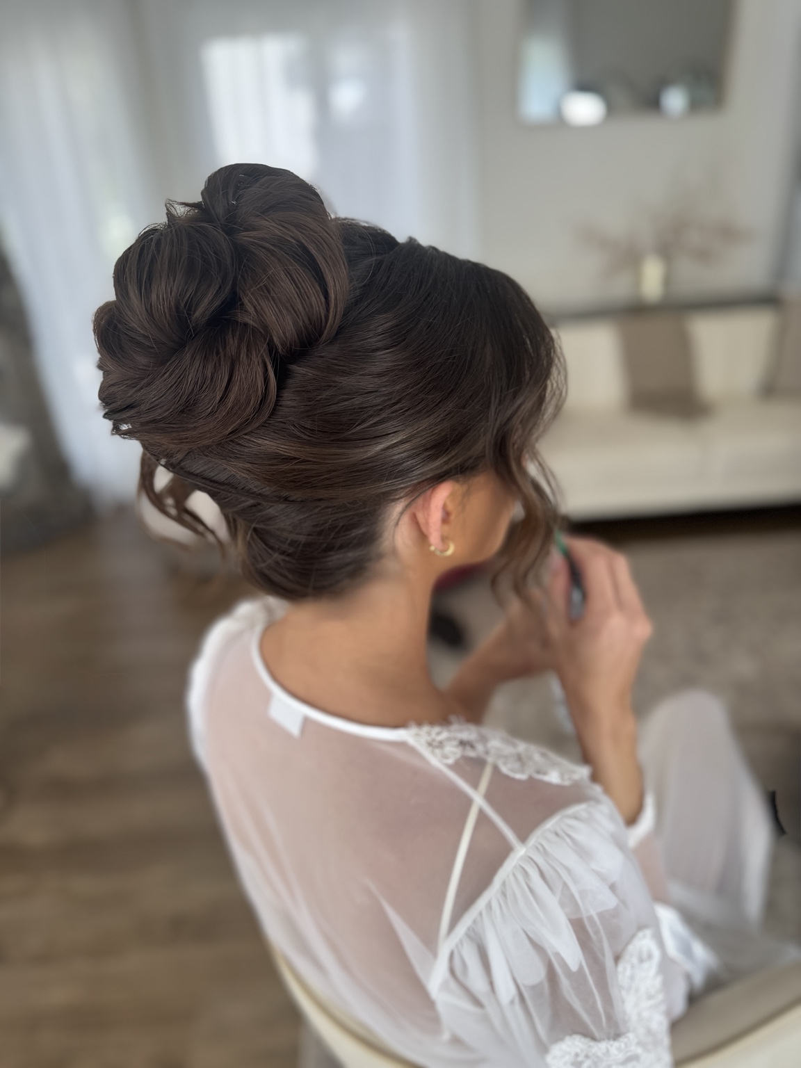 Brunette bride with an intricate updo from the side