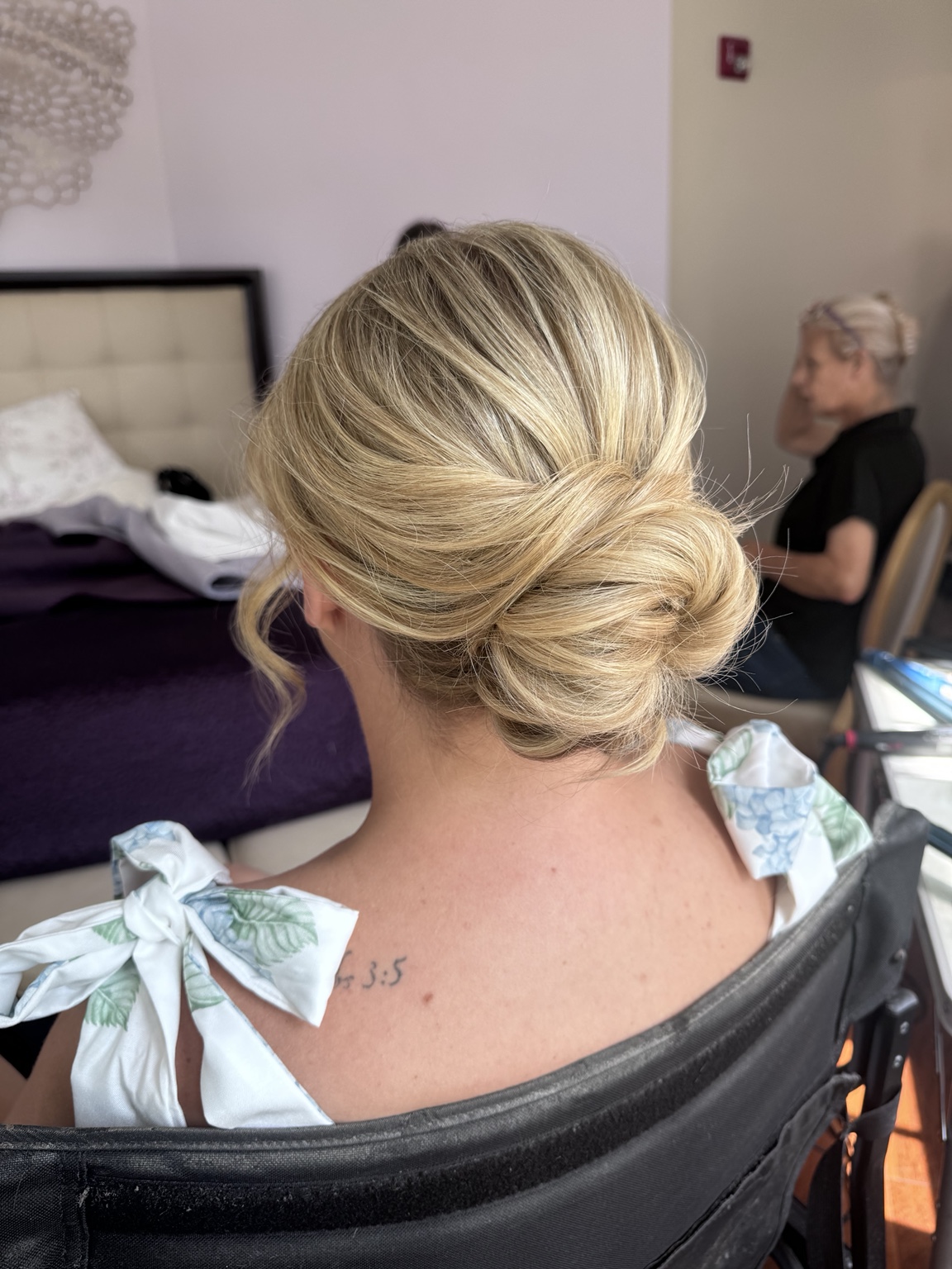 Blonde low bun styled for an event