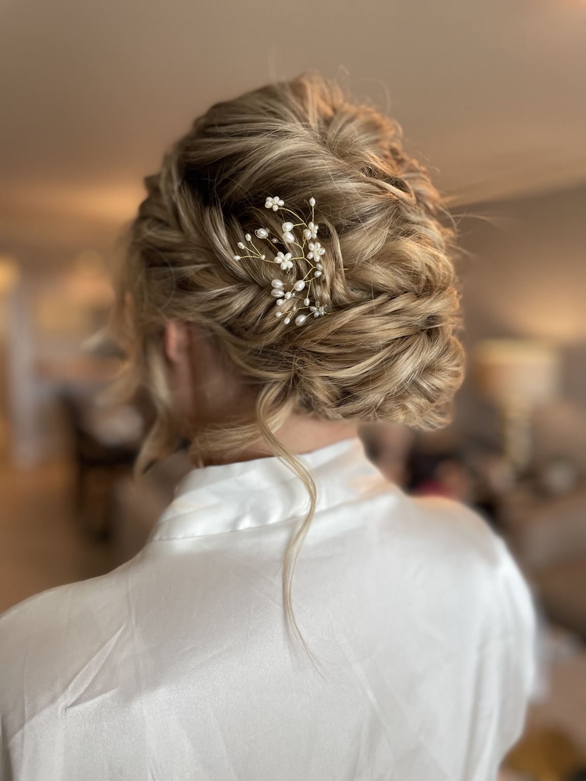 Textured blonde bridal updo with decorative pins